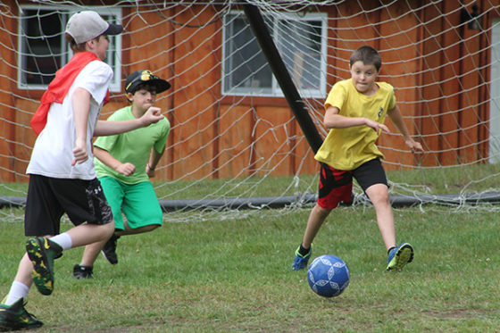 Campers playing soccer on the field at Arrowhead Camp