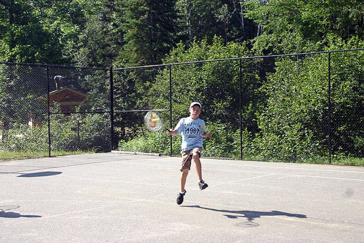 Camper playing tennis at Arrowhead Camp