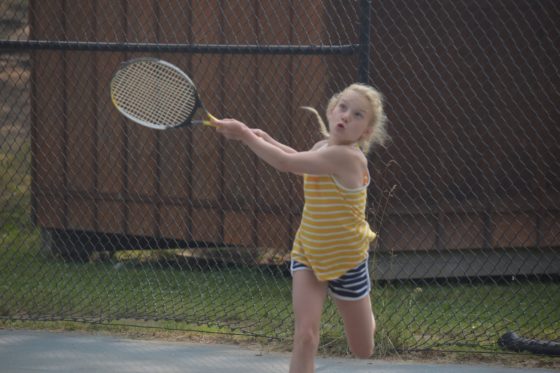 Girl camper playing tennis at Arrowhead Camp.