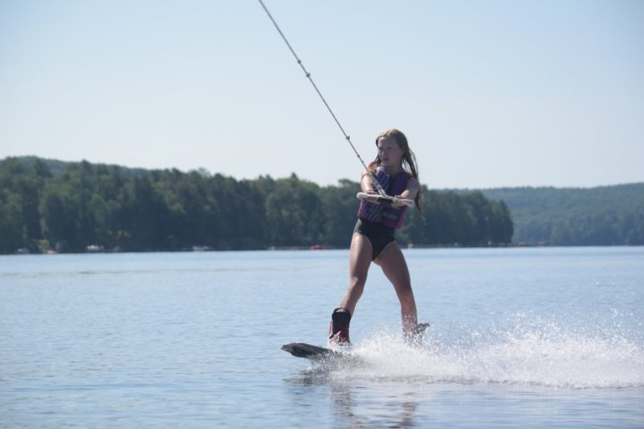 Girl camper going Wakeboarding at Arrowhead Camp.